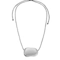 A silver pendant necklace with a rounded bean pendant attached to an adjustable black cord. Refined, wearable statements that elevate the everyday. Sloane corded pendant necklace by Arella The Label — vintage-inspired adjustable cord necklace with silver pendant
